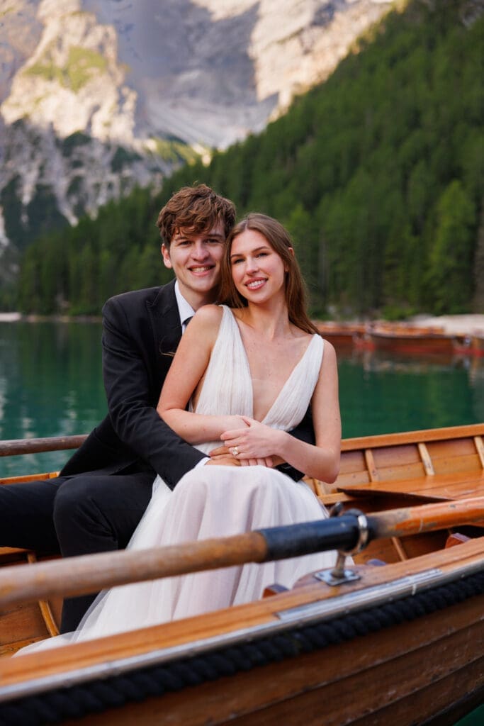 Couple in a canoe on Lago di Braies surrounded by the Dolomites